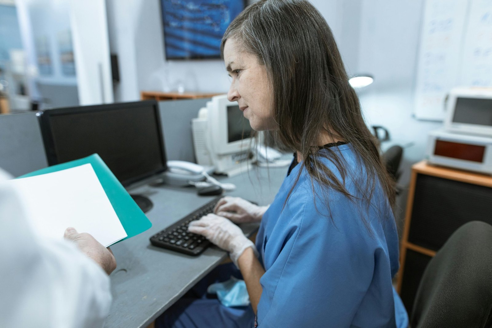 Frustrated medical professional reviewing denied insurance claims on a computer